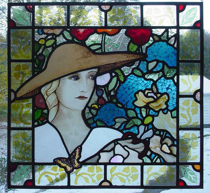stained glass of woman in garden with peonies, roses, and hydrangeas, silver stain border
